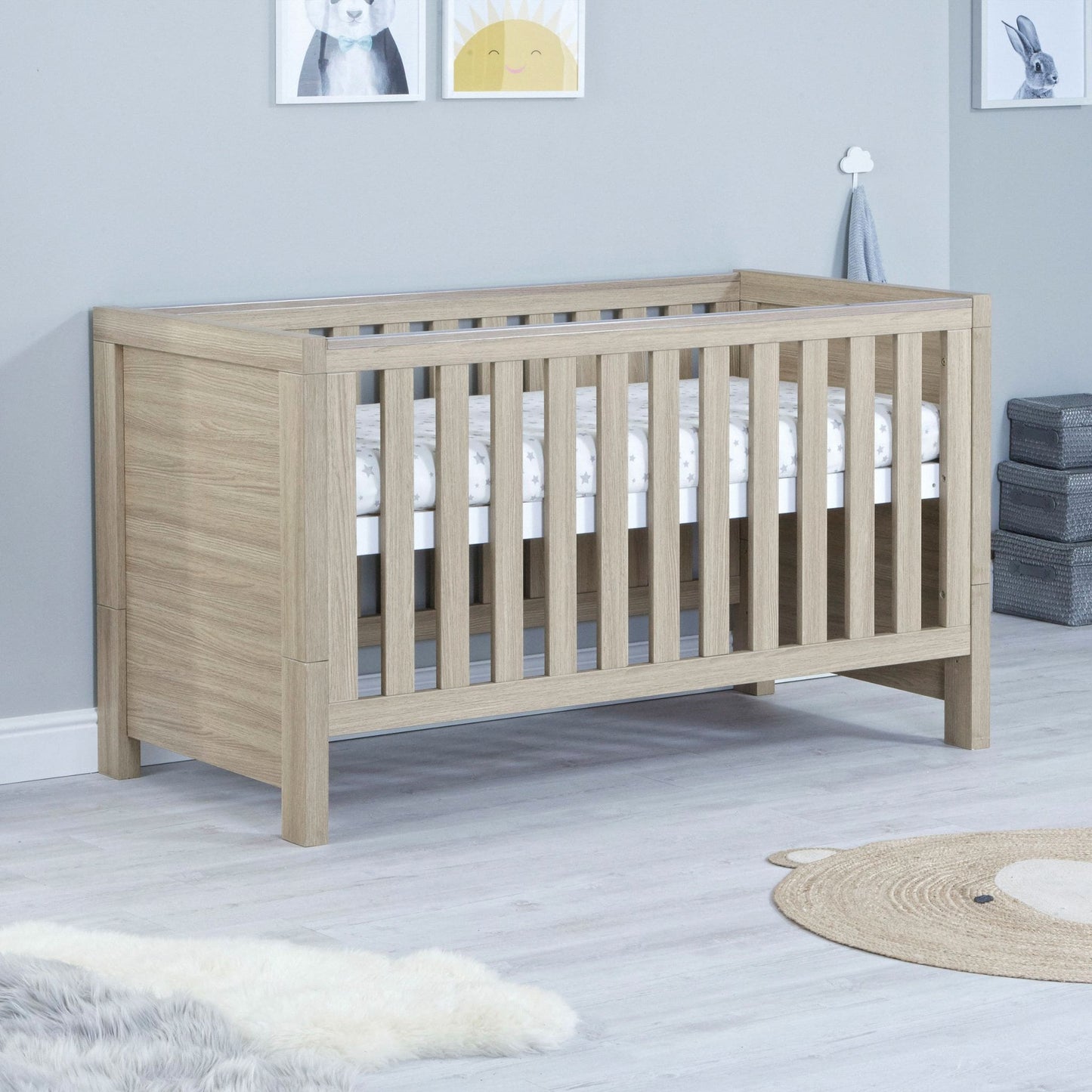 Babymore-Luno-Cot-Bed-oak-in-nursery-setting-as-cot-side1