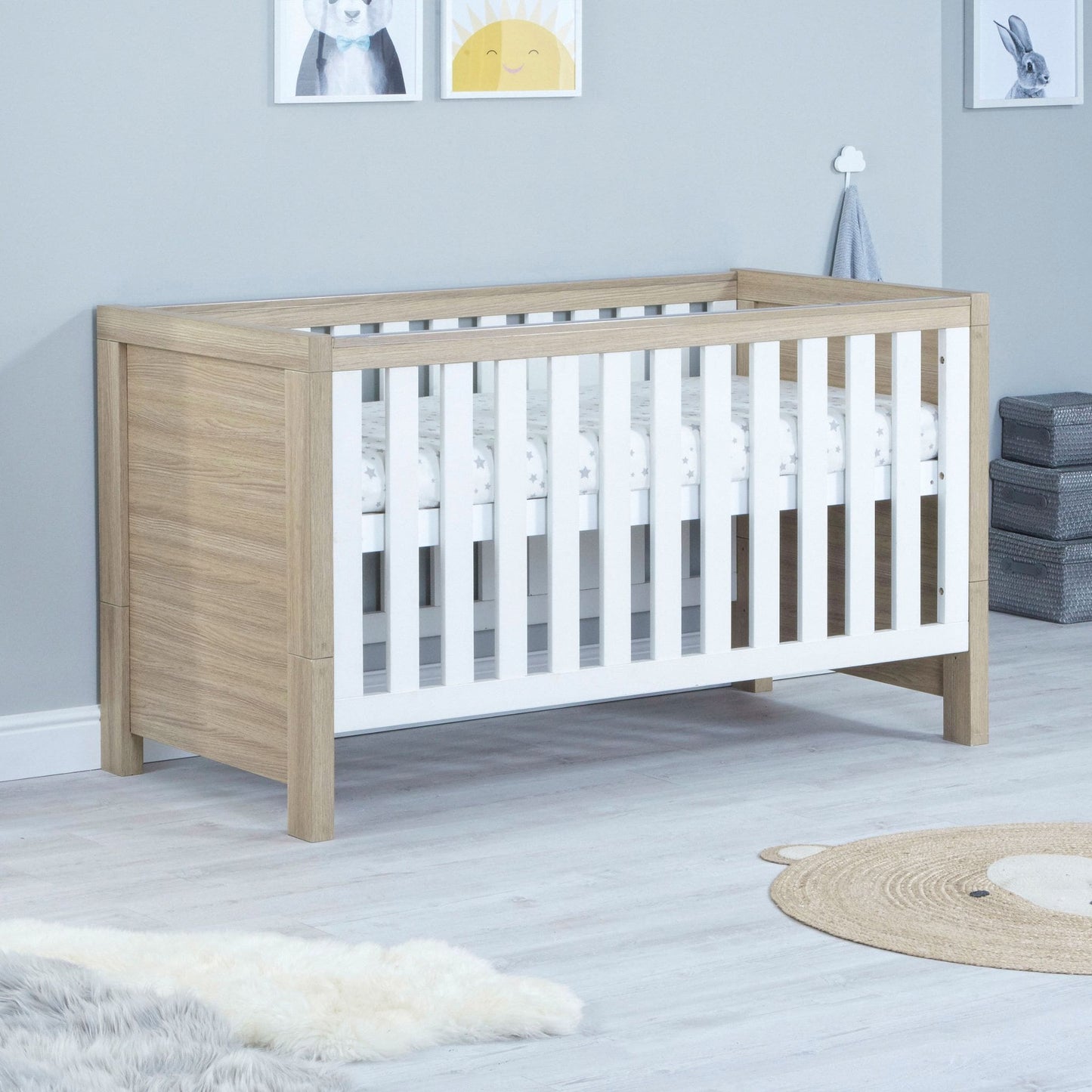 Babymore-Luno-Cot-Bed-oak-white-in-nursery-setting-as-cot-side