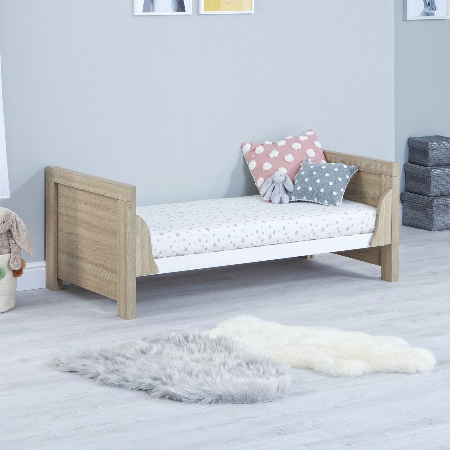 Babymore-Luno-Cot-Bed-oak-white-in-nursery-setting-as-cot-bed-side