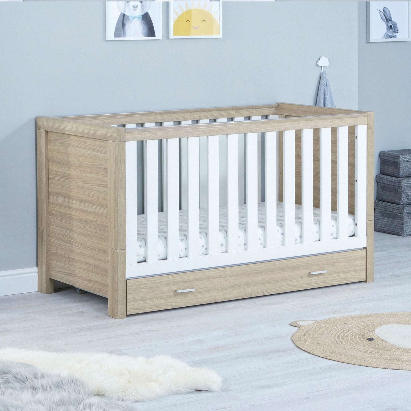 Babymore-Luno-Cot-Bed-oak-white-with-drawer-in-nursery-setting-as cot-side