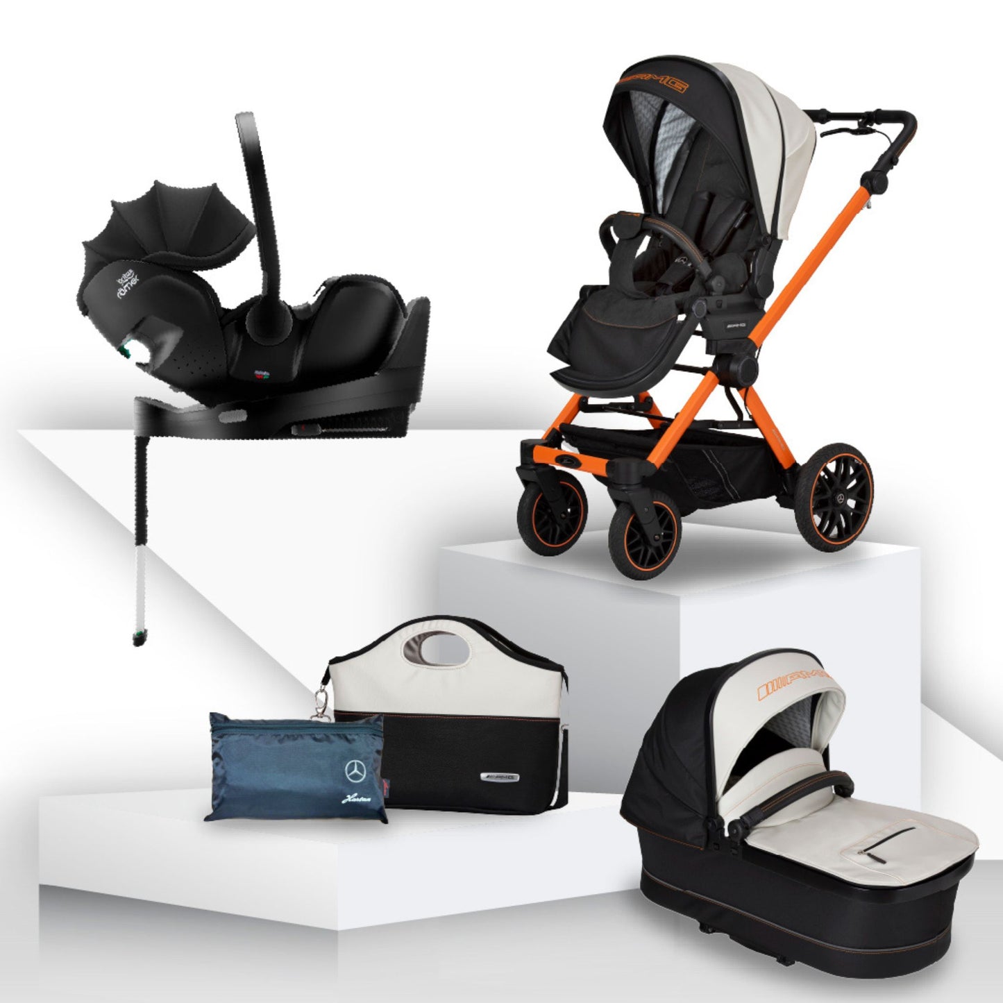White and black baby stroller, with orange detailing, carrycot, pushchair car seat, and accessories on a white background