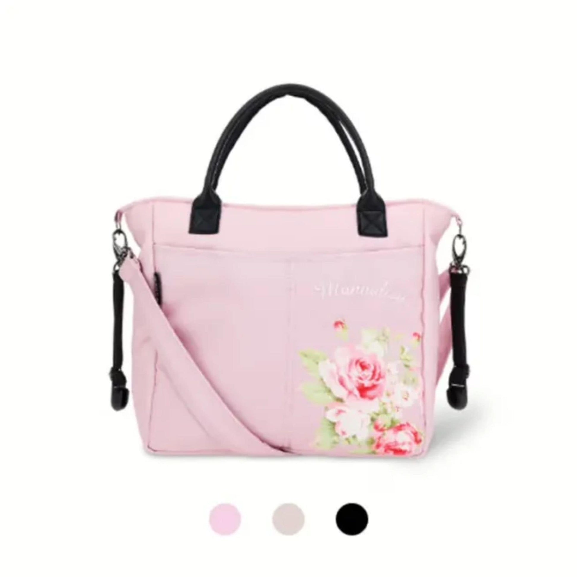 Changing bag with flowers and black handles with pink bag and strap