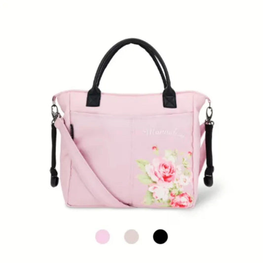 Changing bag with flowers and black handles with pink bag and strap