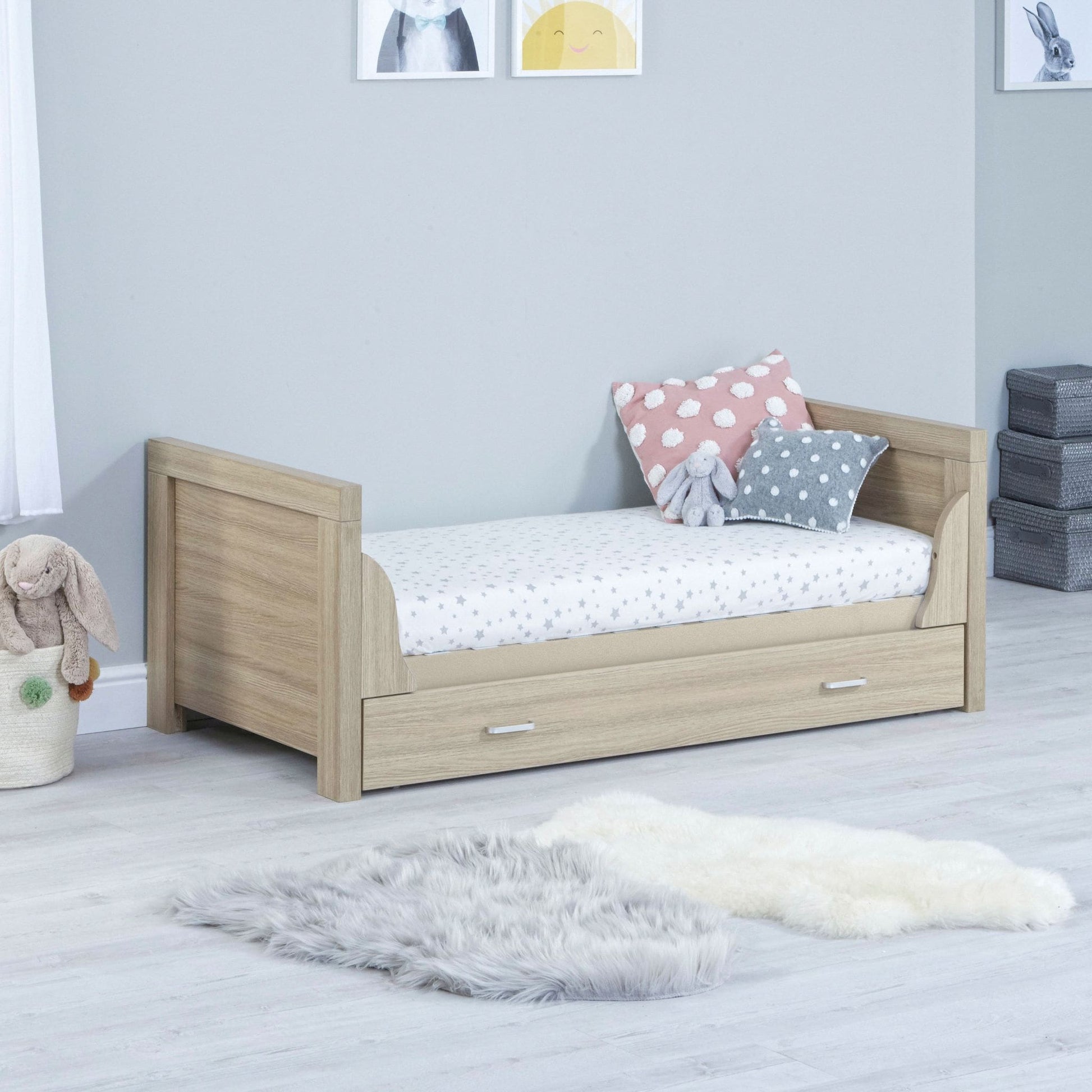 Babymore-Luno-Cot-Bed-with-drawer-oak-in-nursery-setting-as-cot-bed-side