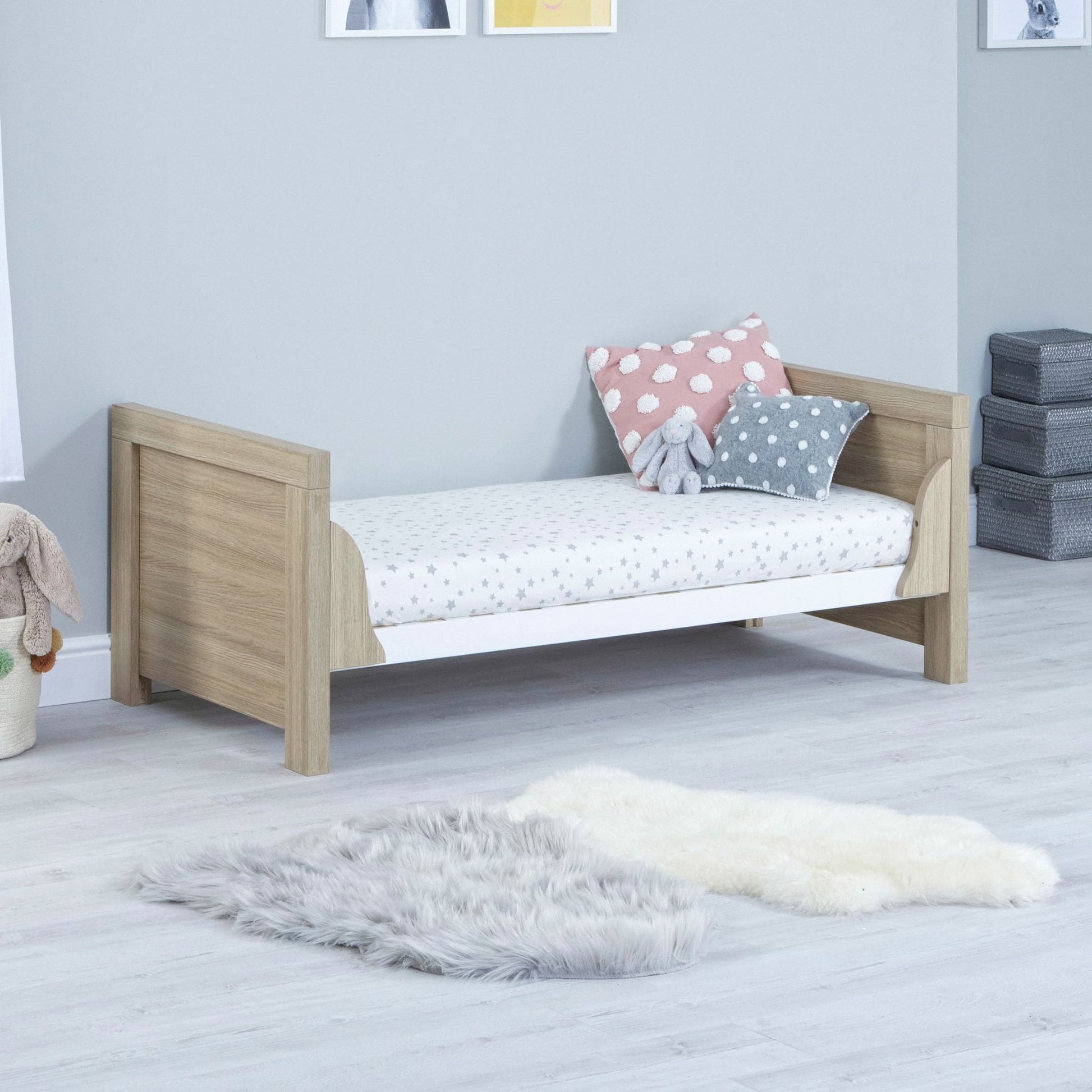Babymore-Luno-Cot-Bed-oak-white-in-nursery-setting-as-cot-bed-side