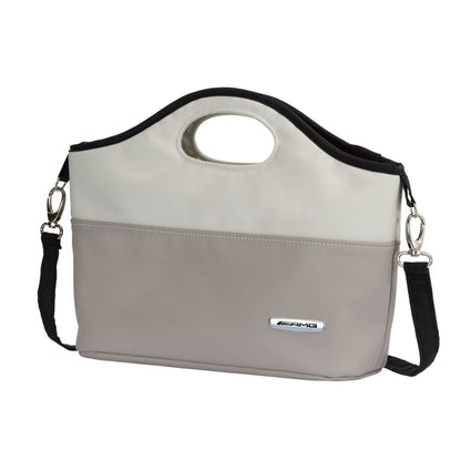 Gray and beige handbag with a black strap on a white background